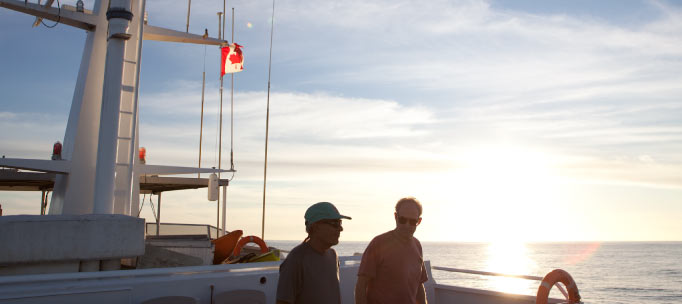 Two guests enjoy the sunset from the sun deck